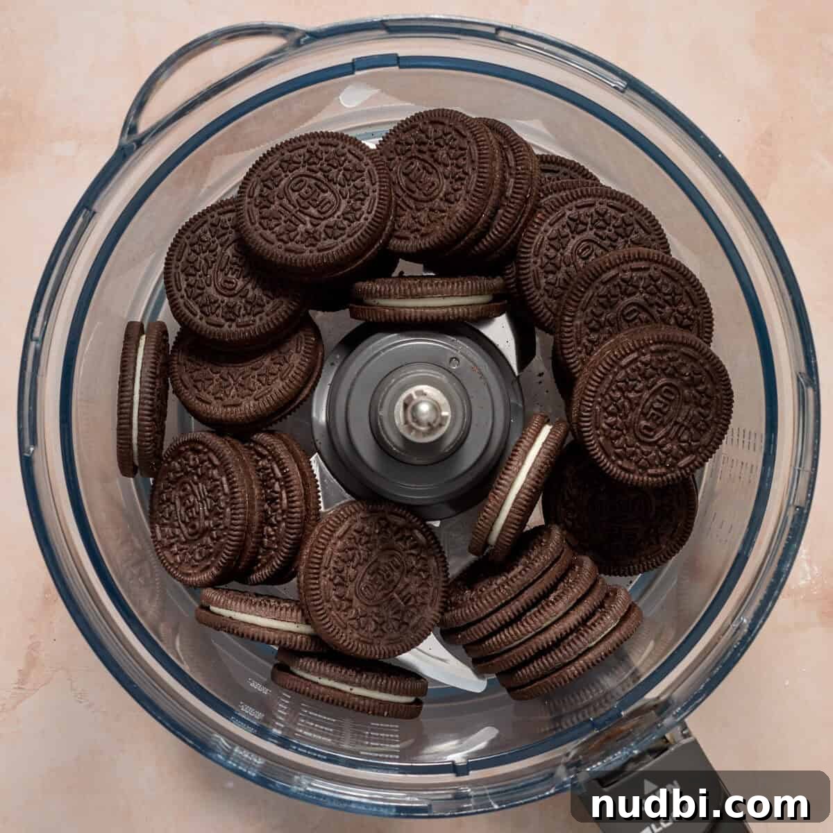 No-Bake Oreo Ice Cream Pie Recipe — Creamy Chocolate Sandwich Dessert 5 Oreo cookies in food processor before being crushed.