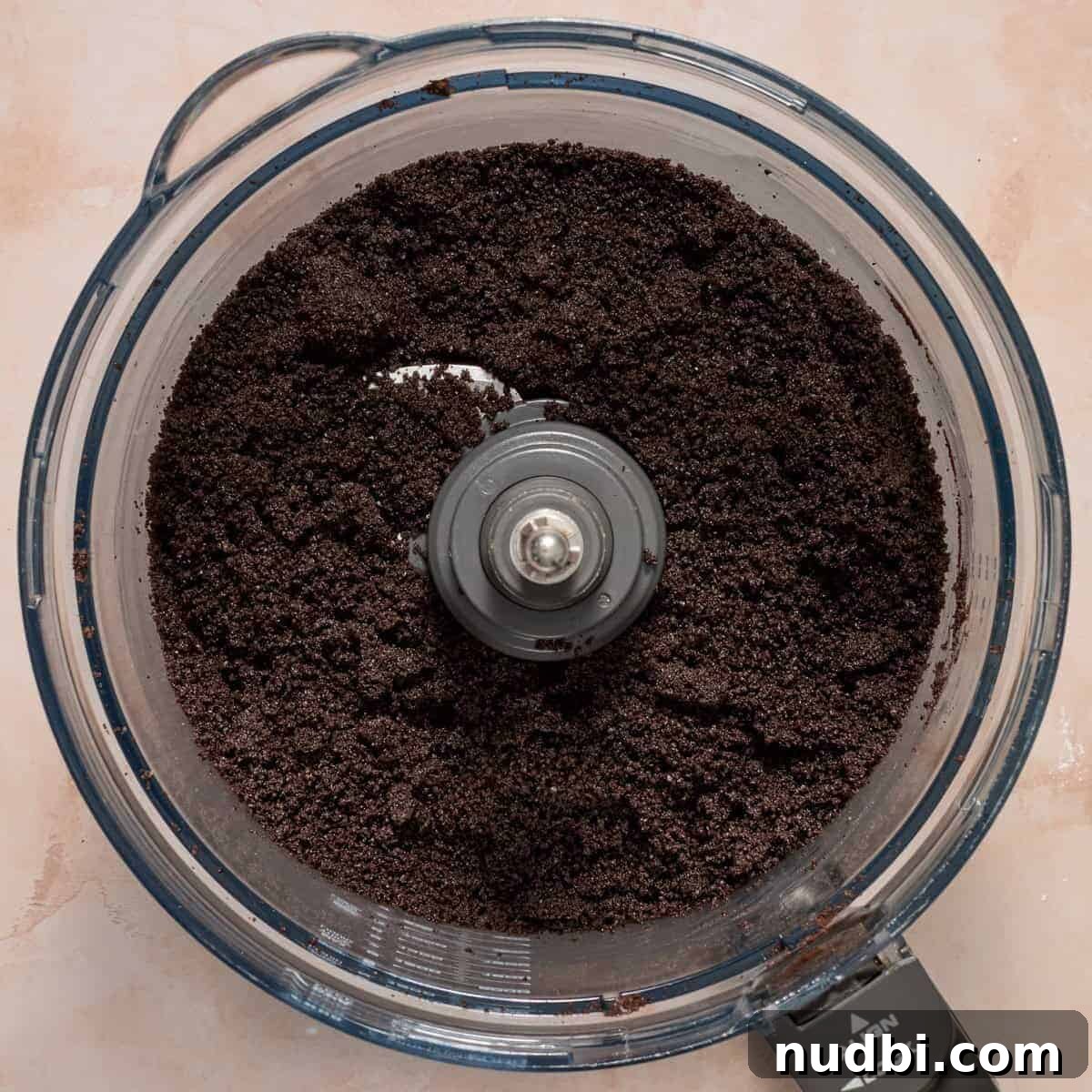 No-Bake Oreo Ice Cream Pie Recipe — Creamy Chocolate Sandwich Dessert 6 Crushed Oreos with butter and espresso powder in food processor.