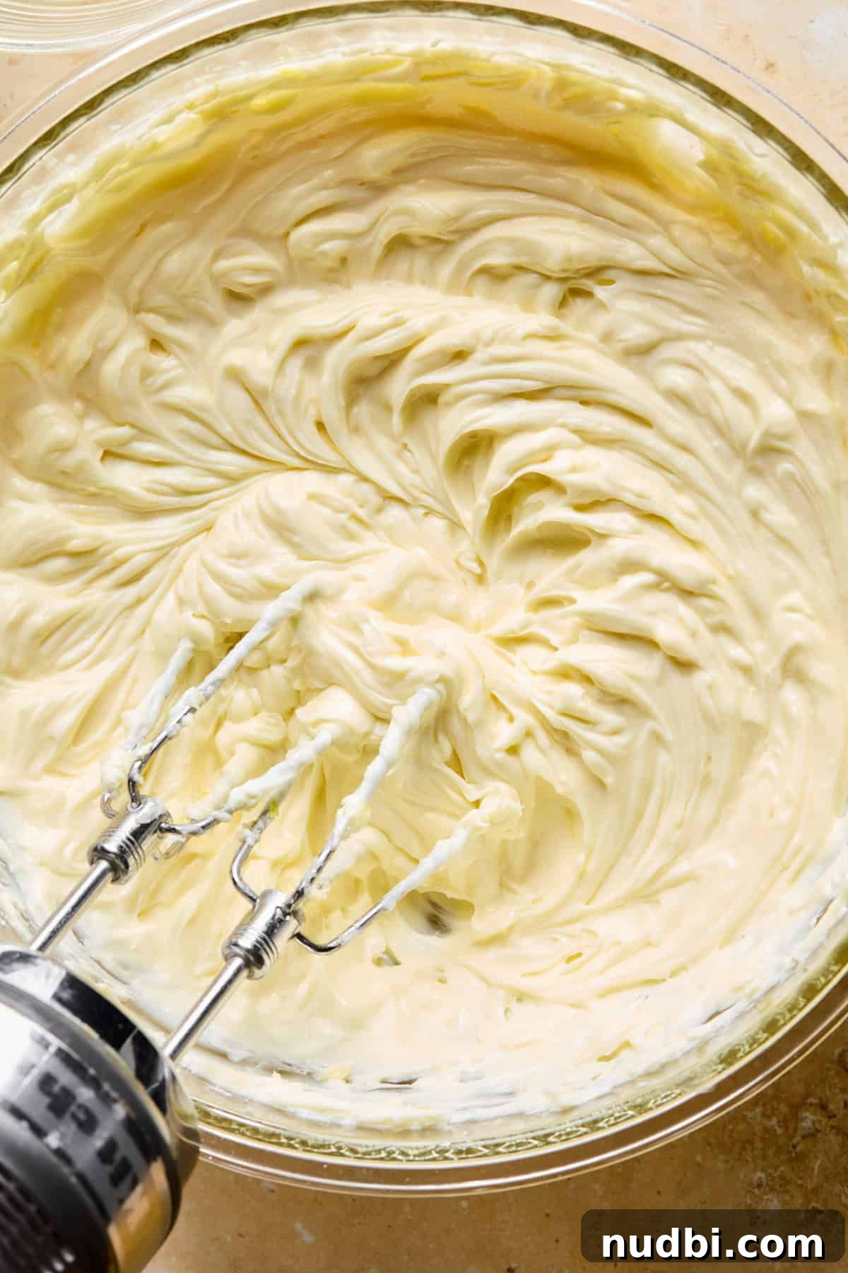 No-Bake Lemon Cheesecake Bars with Zesty Graham Crust 11 Lemon cheesecake mixture with hand mixer above.