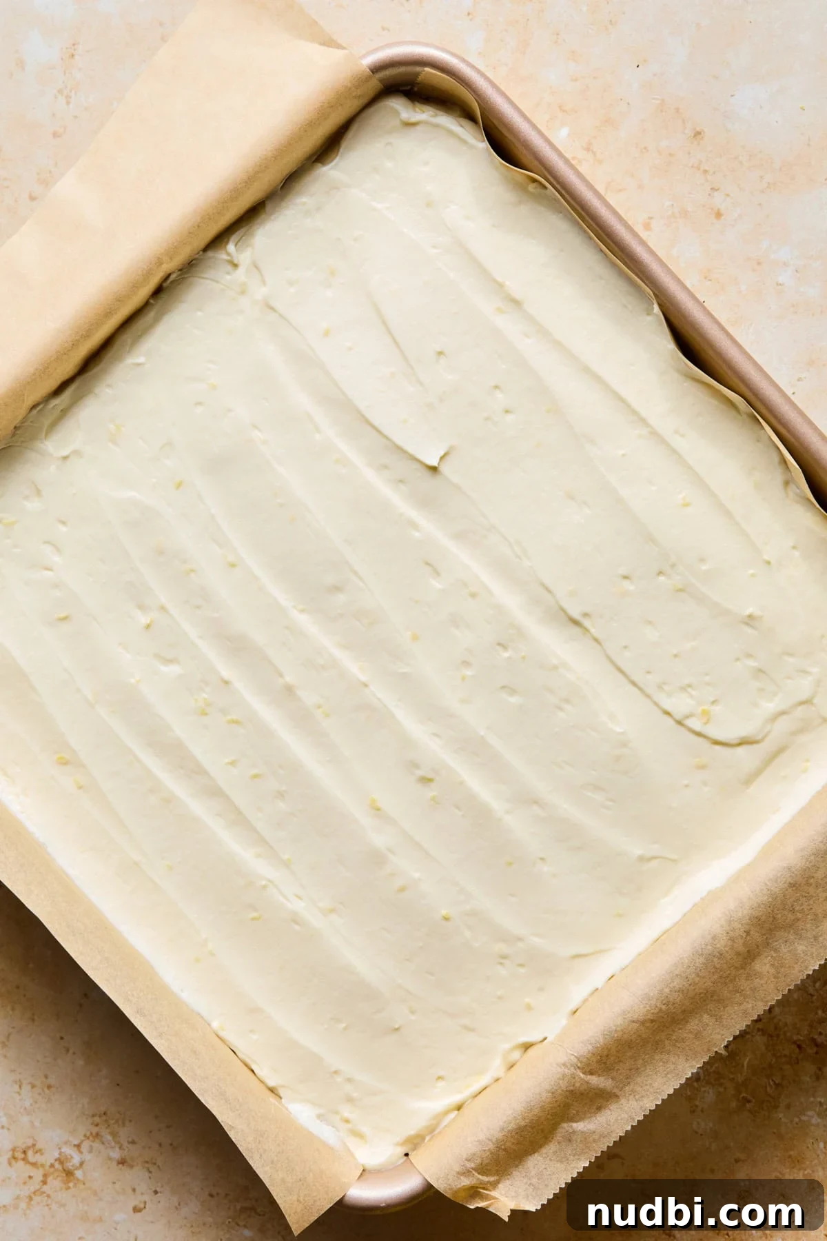 No-Bake Lemon Cheesecake Bars with Zesty Graham Crust 14 No-bake lemon cheesecake in pan spread evenly.