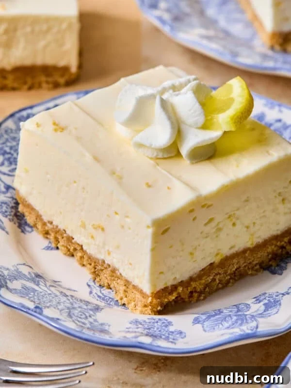 No-Bake Lemon Cheesecake Bars with Zesty Graham Crust 16 Piece of lemon cheesecake bar on plate.