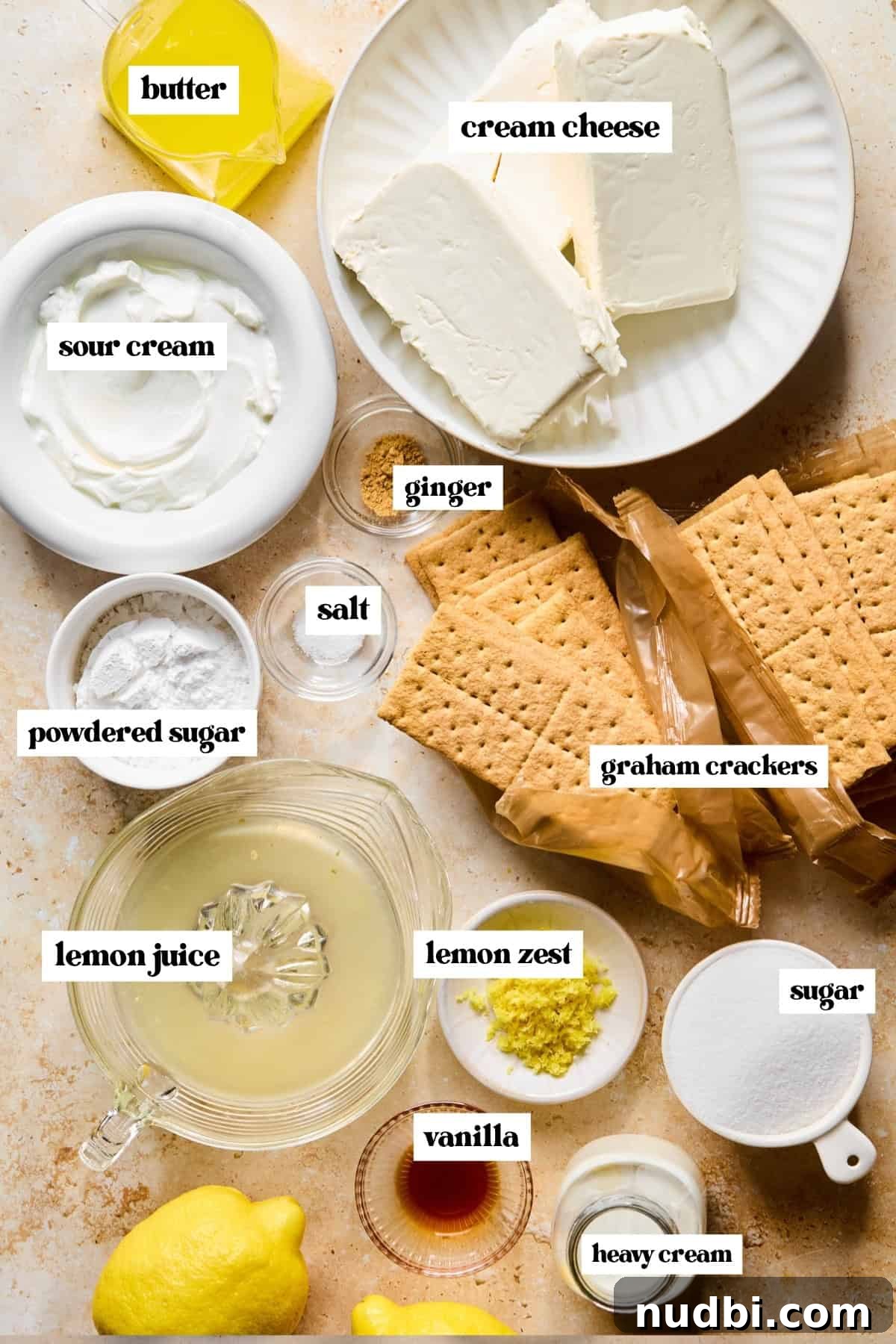 No-Bake Lemon Cheesecake Bars with Zesty Graham Crust 4 Graham crackers, cream cheese, sugar, lemon zest, and other labeled ingredients on surface.
