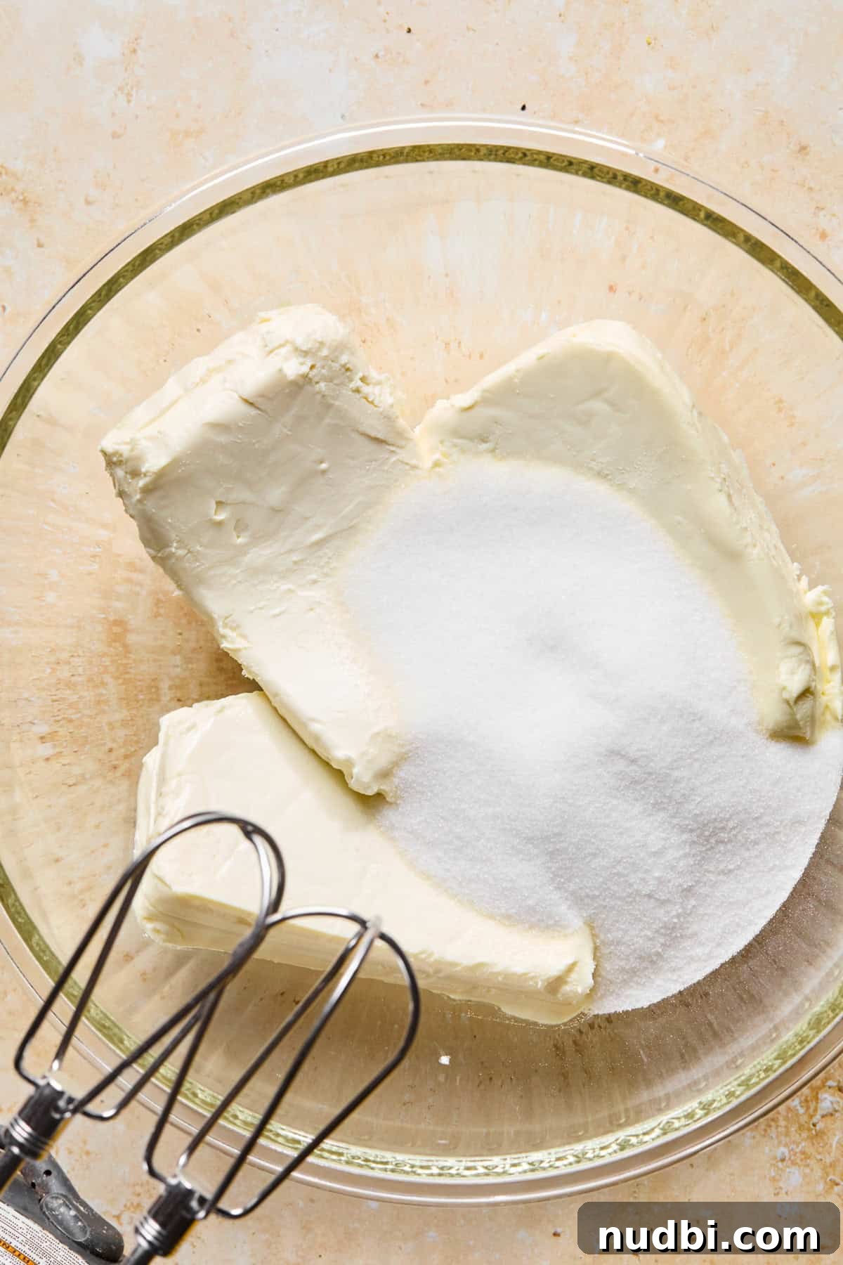 No-Bake Lemon Cheesecake Bars with Zesty Graham Crust 9 Cream cheese can sugar in glass bowl.