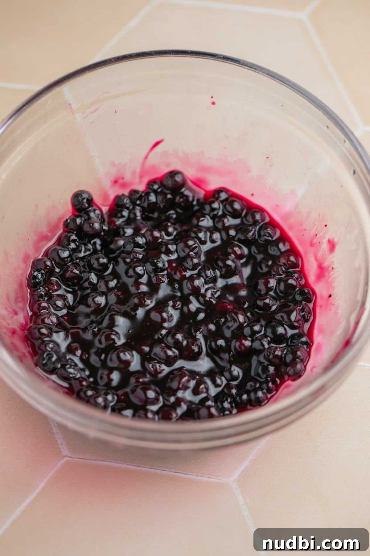 Creamy Blueberry Cheesecake Overnight Oats Recipe 4 Small bowl with blueberry sauce.