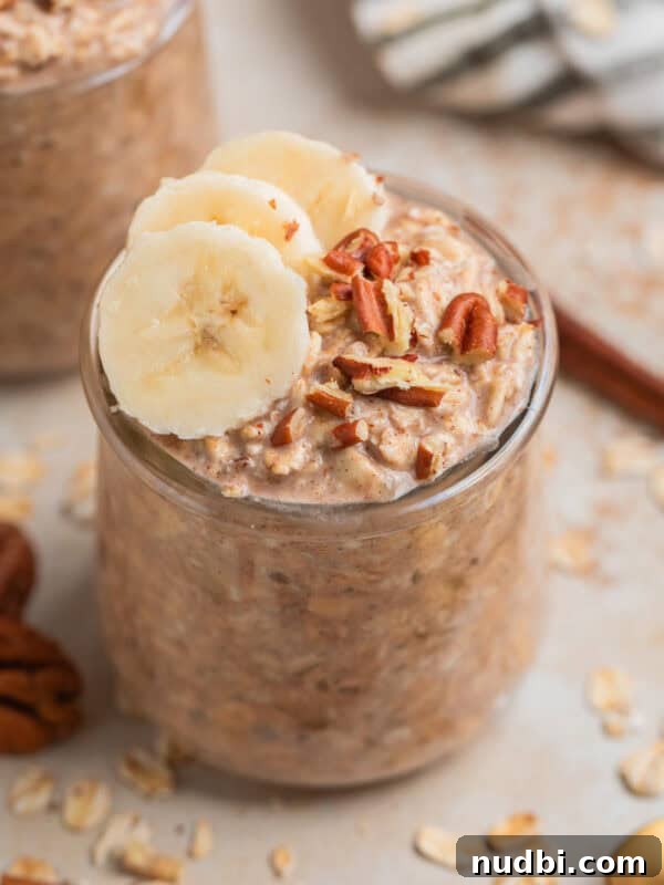 Creamy Blueberry Cheesecake Overnight Oats Recipe 10 Glass jar with overnight oatmeal topped with bananas and nuts.