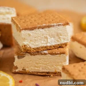 Lemonade Ice Cream Sandwiches Recipe — Refreshing Summer Treat 13 Lemonade ice cream sandwiches stacked on top of each other on parchment.