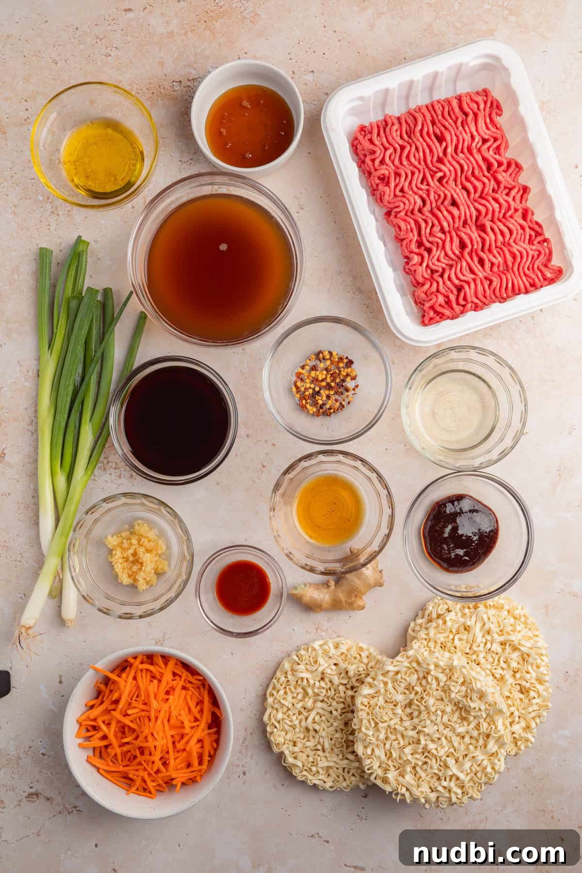 Savory Ground Beef Ramen Noodle Recipe 4 Ground beef, carrots, onions, hoisin sauce and other ingredients arranged on surface for recipe.