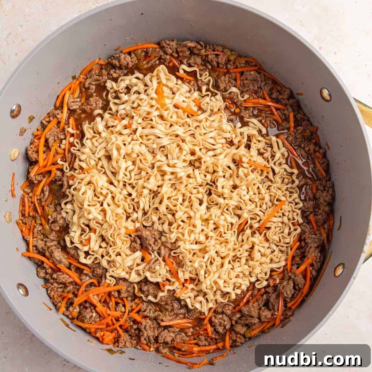 Savory Ground Beef Ramen Noodle Recipe 9 Ramen noodles softened and spread out more in pan.
