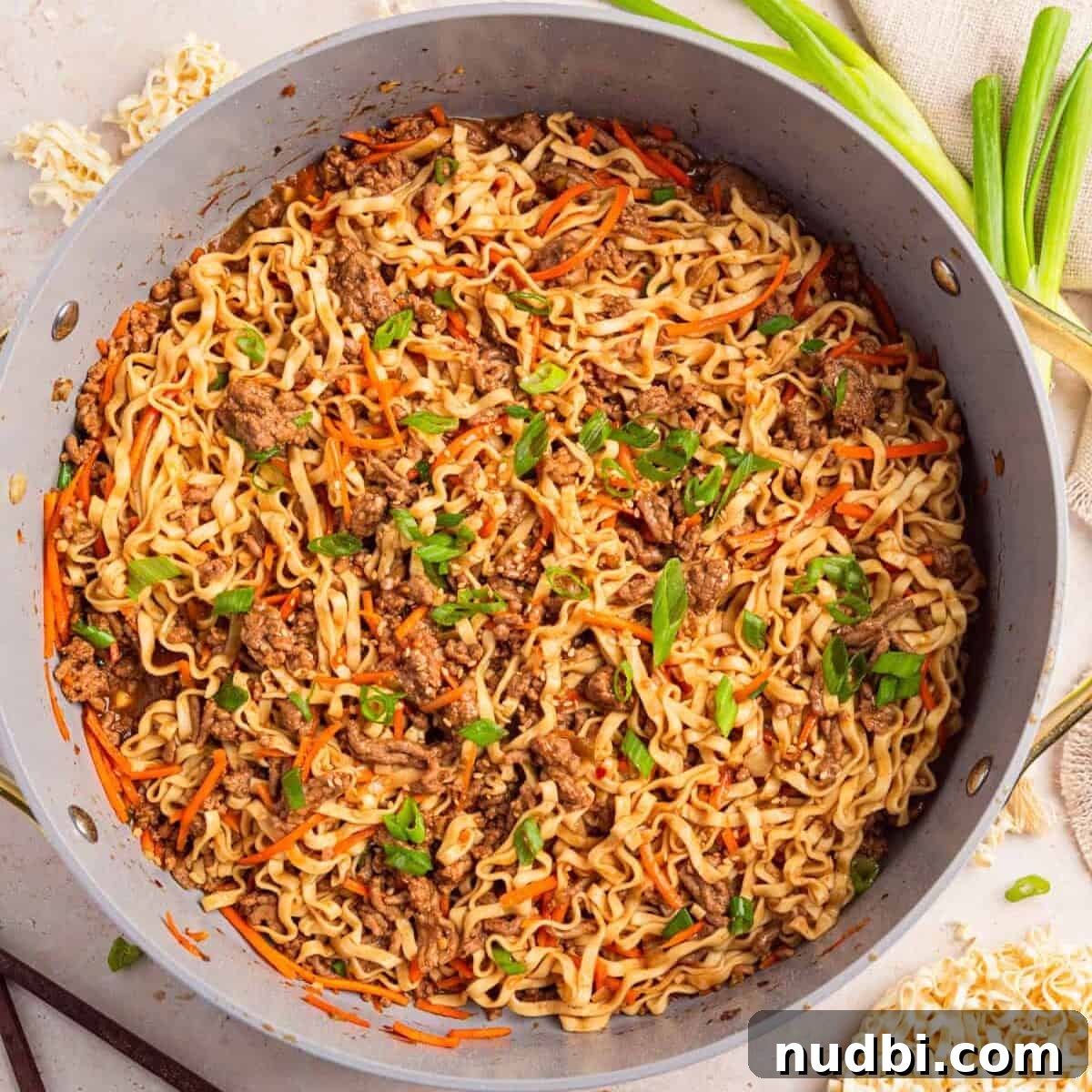 Savory Ground Beef Ramen Noodle Recipe 10 Pan with ground beef one-pot ramen topped with green onions.