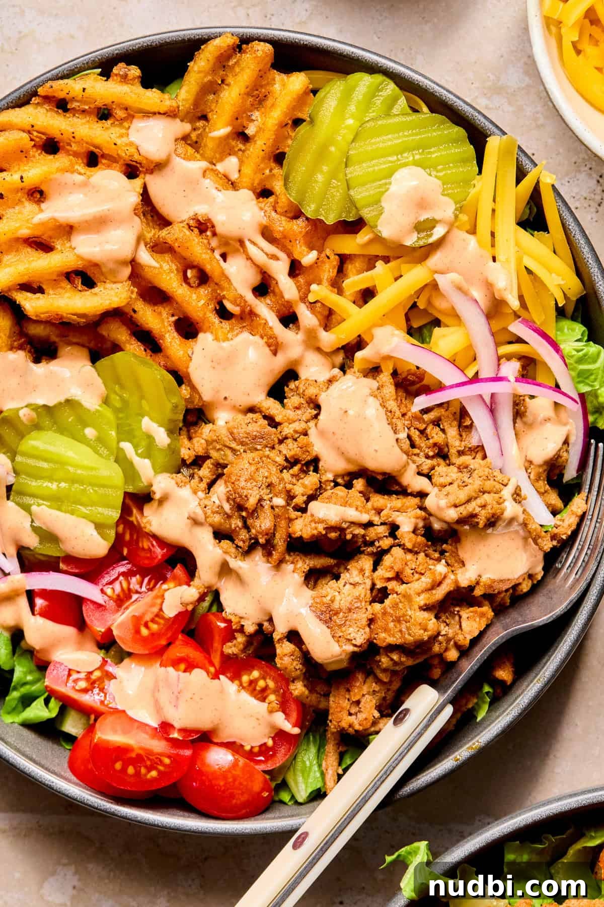 Turkey Burger Bowls with Creamy Special Sauce 2 Turkey burger bowls with waffle fries, pickles, cheese and sauce.