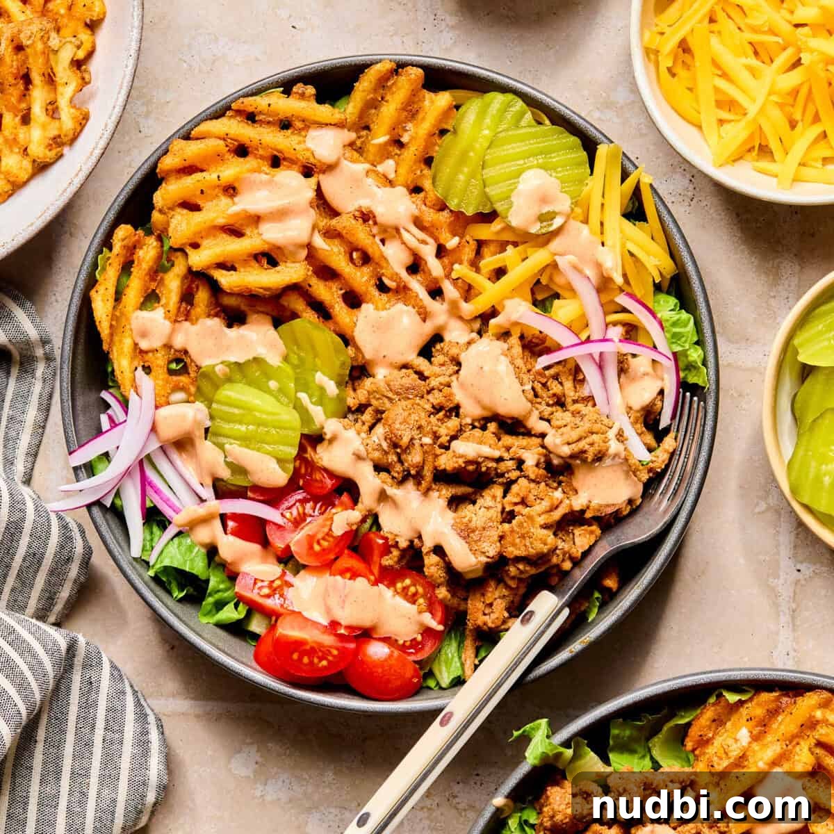 Turkey Burger Bowls with Creamy Special Sauce 10 Turkey burger bowls with waffle fries, tomatoes, lettuce and special sauce over top.