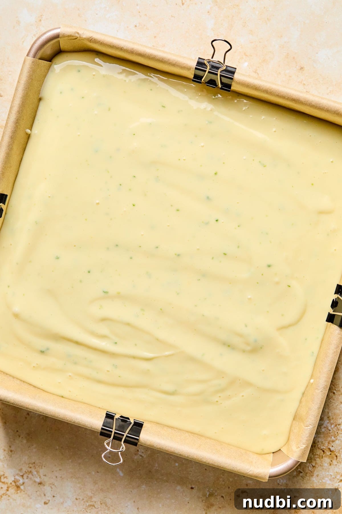 Margarita Bar Ideas for Parties and Entertaining 9 Square baking pan with creamy margarita bar mixture before baking.