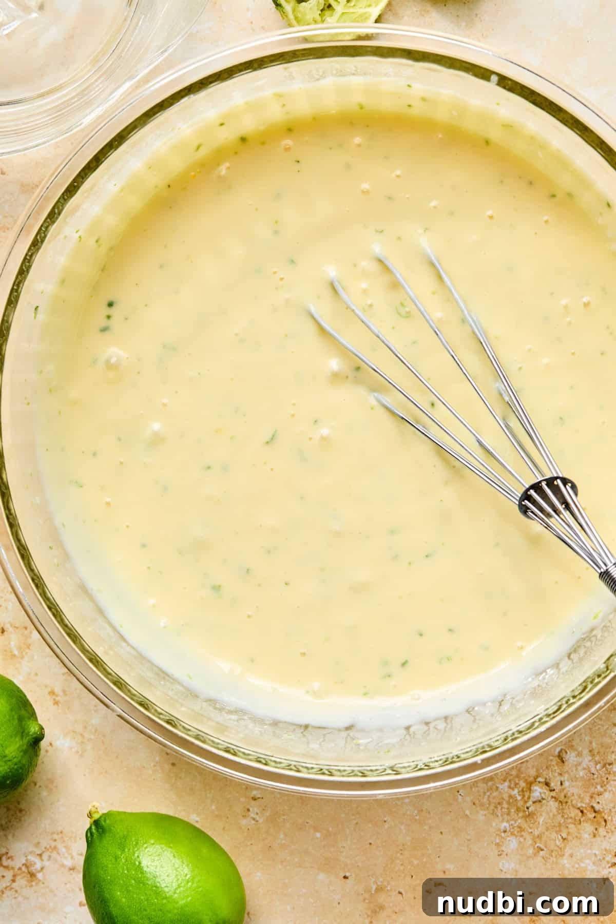 Margarita Bar Ideas for Parties and Entertaining 8 Lime zest, lime juice, eggs, sweetened condensed milk and other ingredients whisked in bowl.