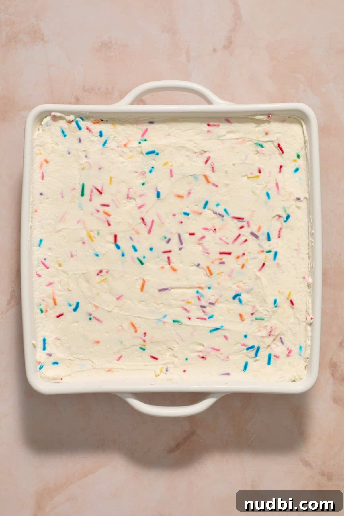 No-Bake Funfetti Icebox Cake Recipe with Whipped Frosting 14 Chilled no-bake funfetti cake in white pan.