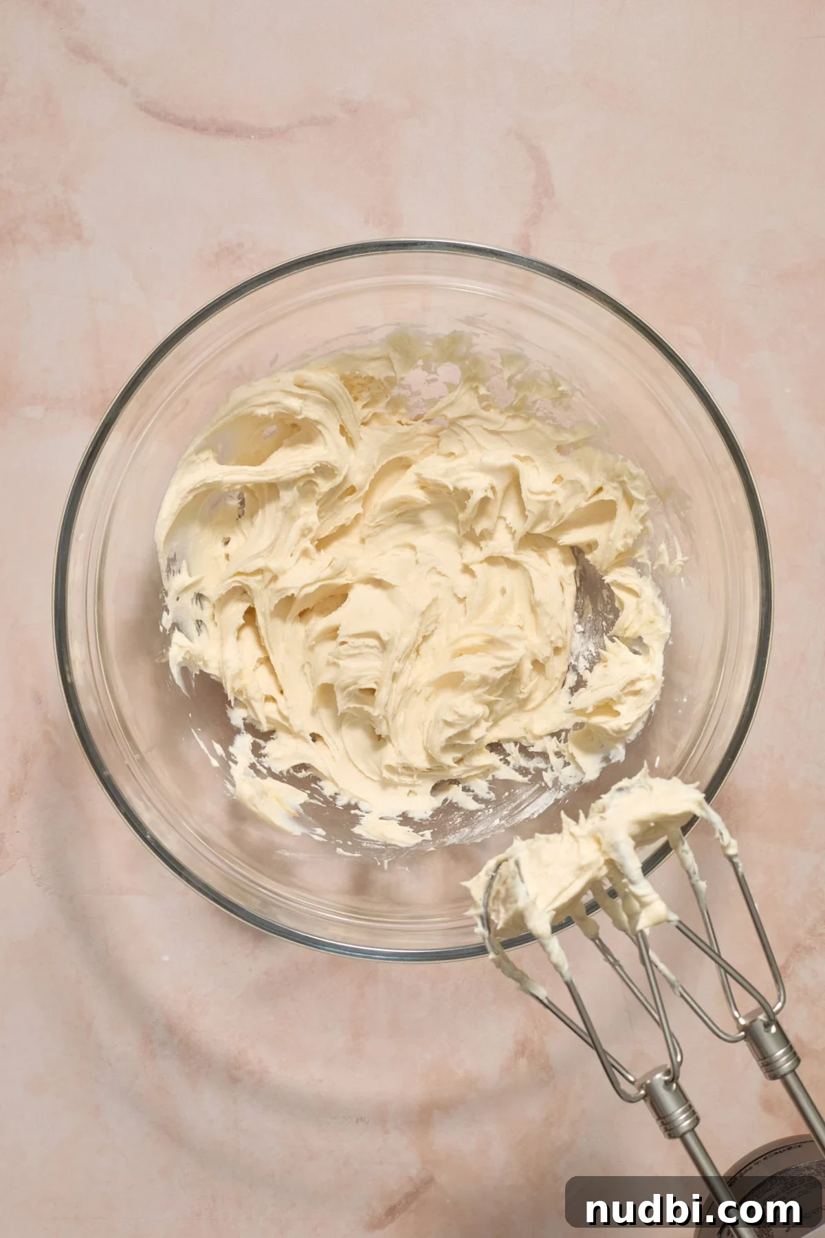 No-Bake Funfetti Icebox Cake Recipe with Whipped Frosting 5 Cream cheese, powdered sugar and vanilla mixed in bowl.