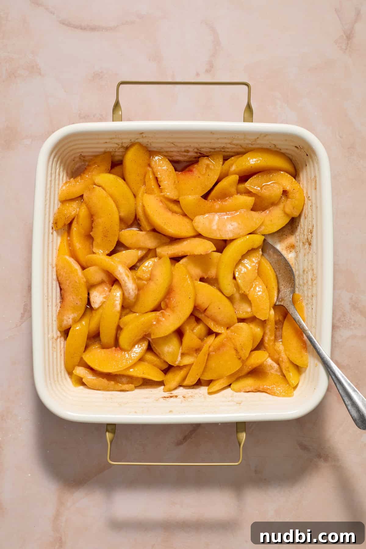 Cream Cheese Peach Cobbler with Buttery Biscuit Topping 5 Sweetened peaches in 8 inch square baking pan.