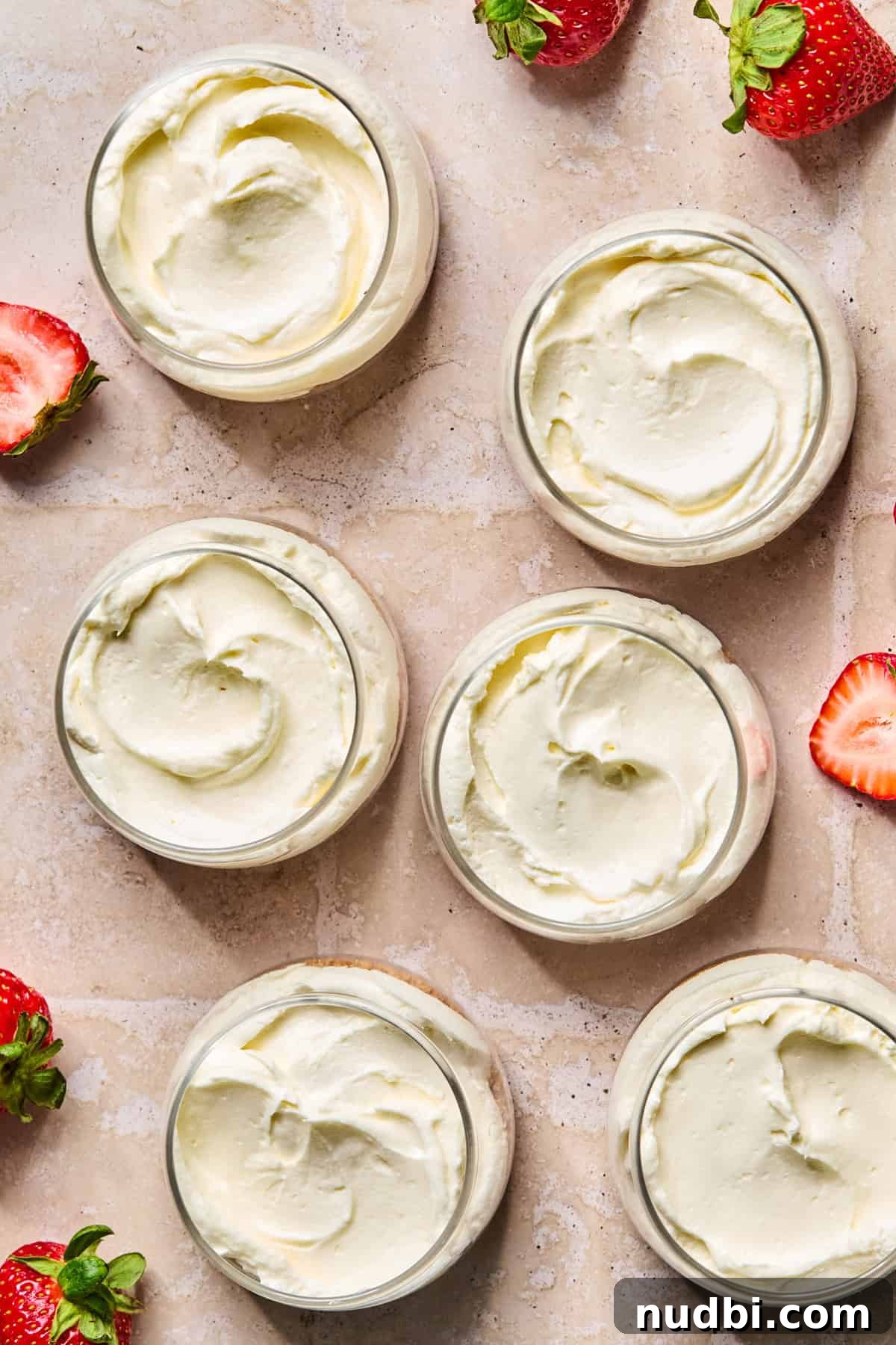 Cheesecake mixture added to dessert cups over graham cracker crust.