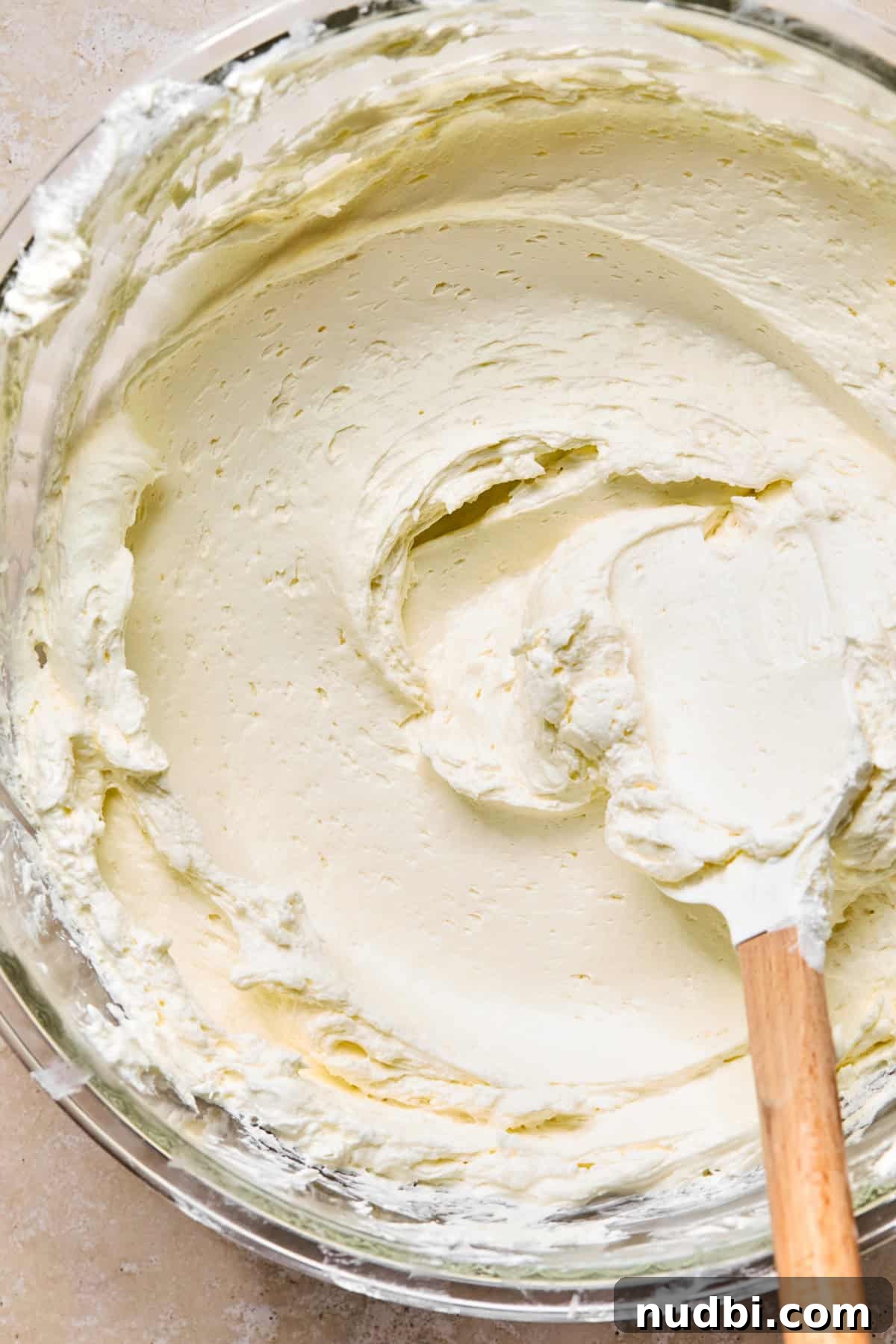 No-bake cream cheese mixture in bowl with spatula.