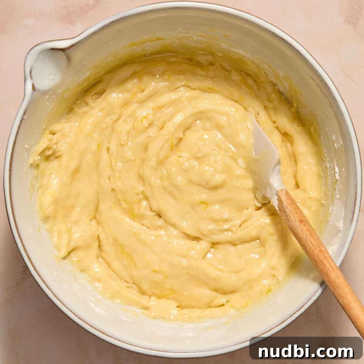 Dry ingredients combined with wet ingredients for lemon zucchini bread recipe.